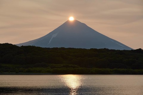 Sunrise over the summit of the Ilyinsky volcano at the Kurilskoye lake