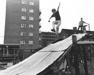 Boy plays on tin slide