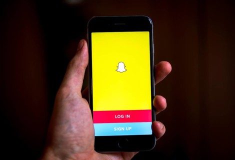 Hand holding iPhone with Snapchat App