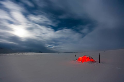 Tent by full moon in the snow