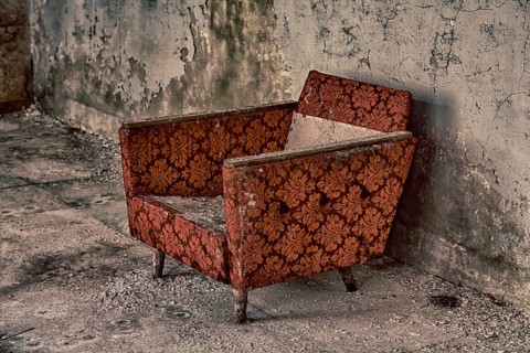 Armchair in destroyed building