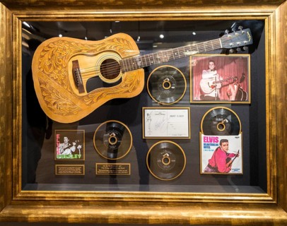 Guitar and records from Elvis Presley in a showcase