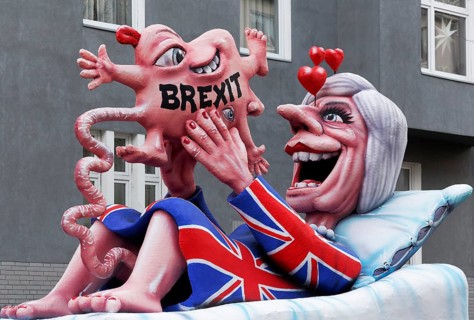 British Prime Minister Theresa May holds a deformed child