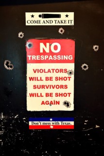 Toilet door with Texas slogans