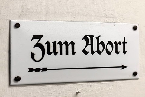 Old enamel sign: Zum Abort