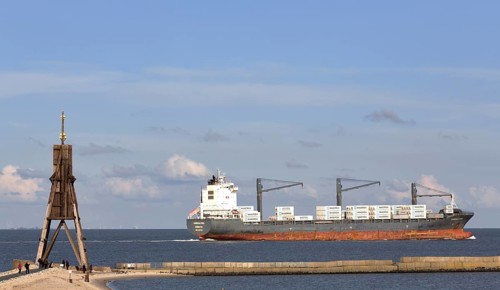 Kugelbake with freighter on the Elbe