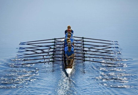 Rowers rowing in rowing boat