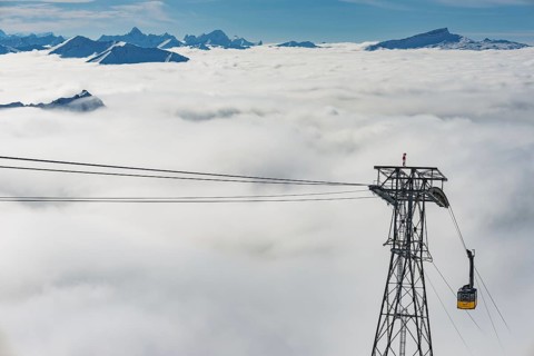 Mountain peaks protrude from clouds