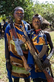 Two young women with Kalashnikovs