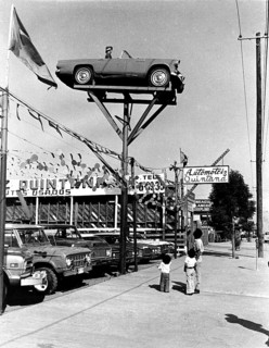 People gazing at car in the air