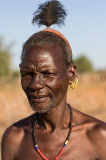 Elderly man with hair ornaments