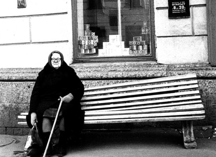 Heavy grandmother sits on the bench