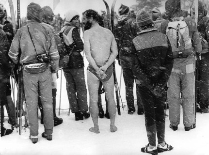 Naked man between skiers ca. 1970s