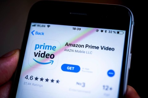 Hand holding iPhone with Amazon Prime Video App in the Apple App Store