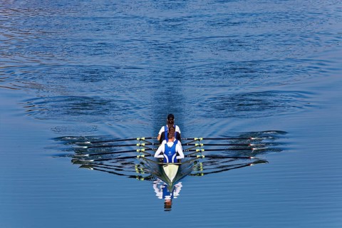 Rowers rowing in rowing boat