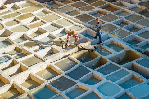 Worker dyeing leather