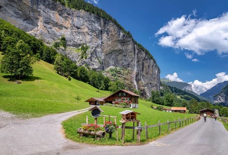 View of a farm house near Lauterbrunnen and with Staubbach Falls in the background