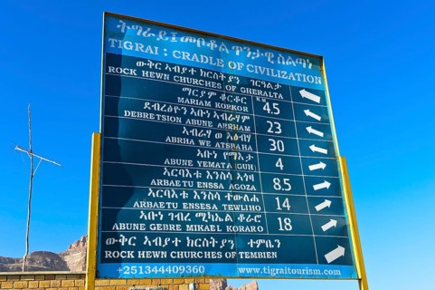 Bilingual signpost in English and Amharic showing rock churches in the Gheralta region