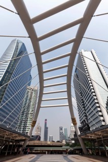 High-rise buildings in the business district Sathon and pedestrian bridge to BTS Skytrain station Chong Nonsi