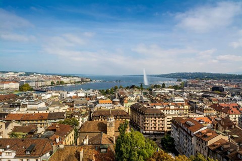 Cityscape with Lake Geneva Lake and the fountain Jet d'eau taken from a tower of the Cathedrale Saint Pierre