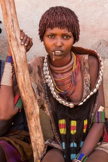 Young woman with traditional clothes from the Hamer tribe