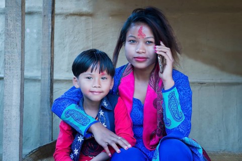 Nepalese woman with her son from the Tharu ethnic group
