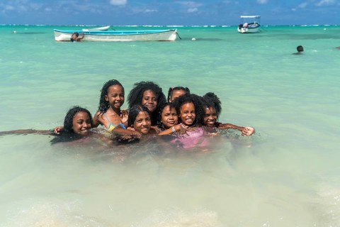 Local children bathing on the beach of Saint Francois