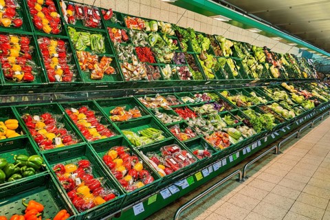 Shelf with packed vegetables in supermarket
