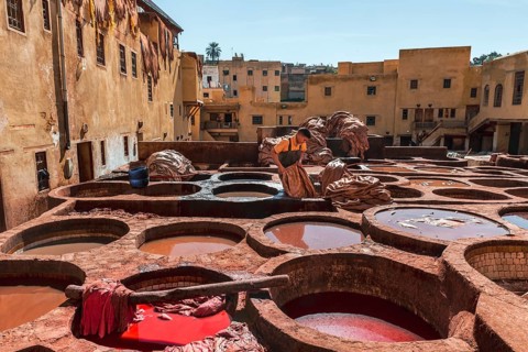 Worker dyeing leather