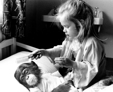 Girl with chimpanzee baby