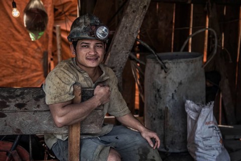 Native with headlamp on the illegal search for gold in mines