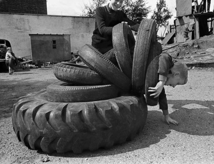 Child playing with tyres