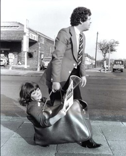 Man carries woman in bag