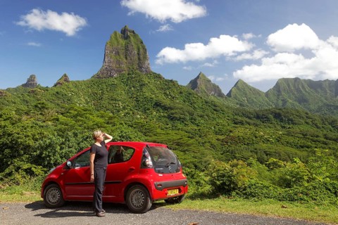 Woman with red car at Belvedere vantage point