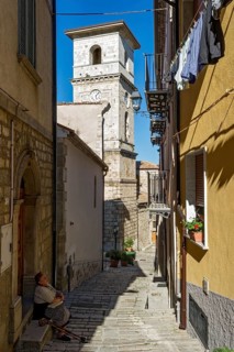 Narrow alley with bell tower of the Cathedral