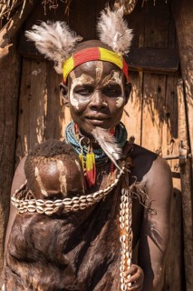 Young woman with toddler in traditional clothes made of goatskin