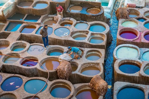 Worker dyeing leather