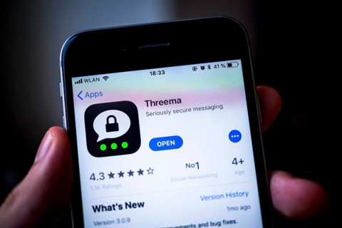 Hand holding iPhone with Threema