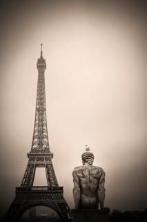Eiffel tower and l'Homme (the Man) statue by artist Pierre Traverse