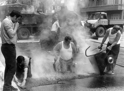 Road workers take tar to the streets