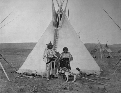 Indian Chief with his wife in front of their tent