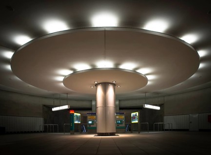 Illuminated column in entrance hall with ticket machine