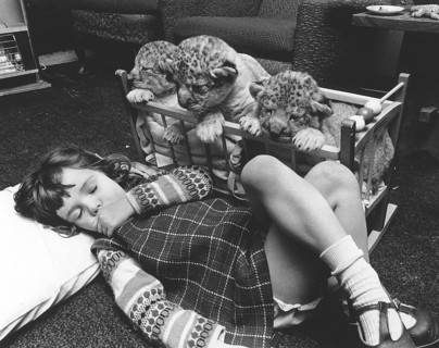 Girl sleeping next to baby predators