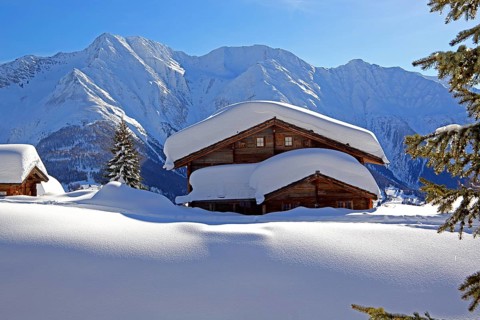 Winter landscape with snow-covered chalet