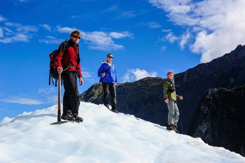 Tourists standing on the icefield of the Fox Glacier