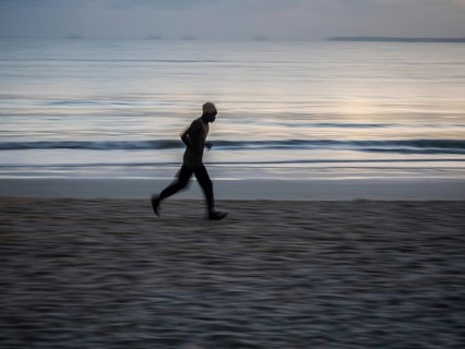 Local athlete doing morning exercise at dawn on the beach at Dar es Salaam