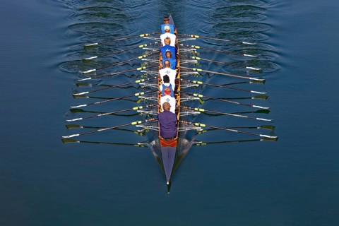 Rowers rowing in rowing boat