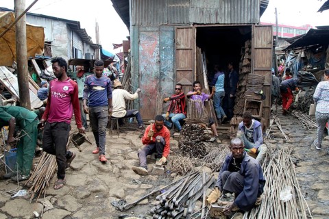 Metal dealer with hardware in front of corrugated-iron huts
