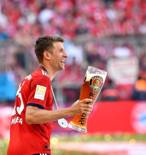 Thomas Muller FC Bayern Munich with Paulaner wheat beer for beer shower