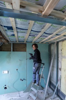 Young woman renovating the attic in an old house